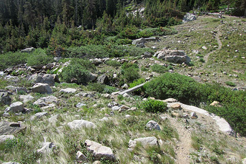 Looking down to the footbridge across Pear Creek at the outlet to the lake