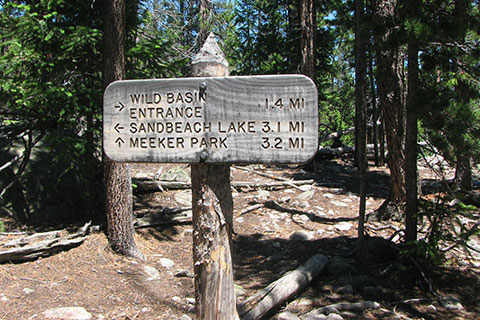 Trail mileage and directional sign at the top of the moraine