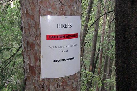 Hikers Caution Advised trail sign warning of damage from a landslide