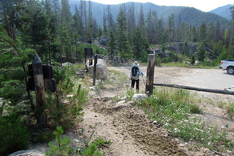 Hiker leaving the Tonahutu Trail exiting past a gate on to Rd 663.