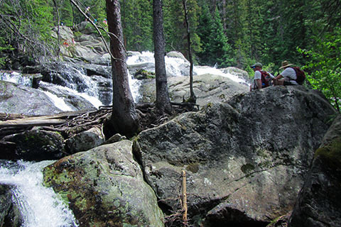 hikers at the base of Cascade Falls